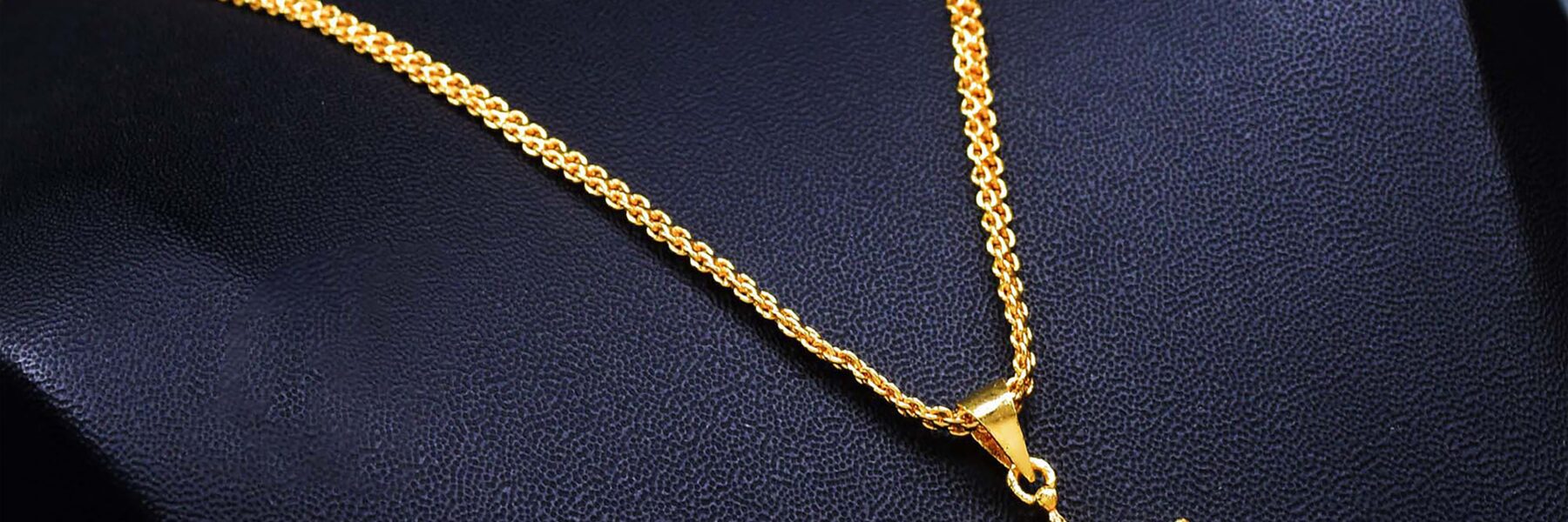 Gold pendant necklace with diamonds on a display stand, a fine jewellery gift