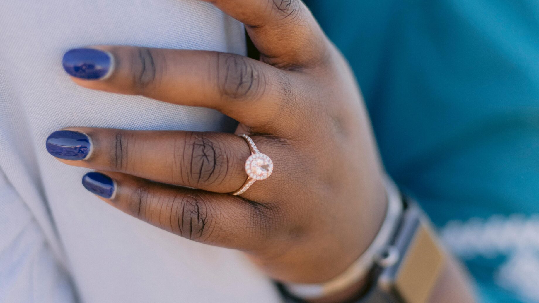 Diamond engagement ring with a prong setting on a hand