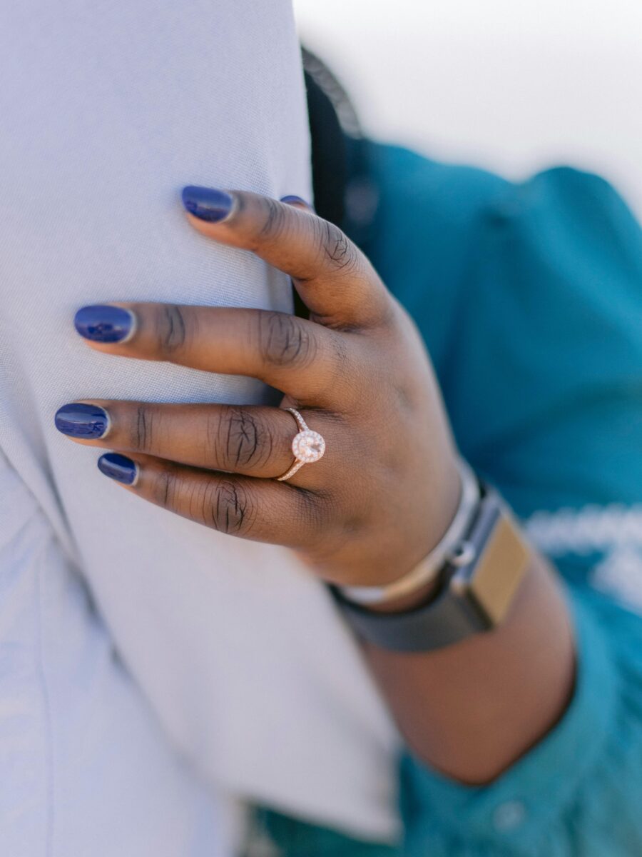 Diamond engagement ring with a prong setting on a hand