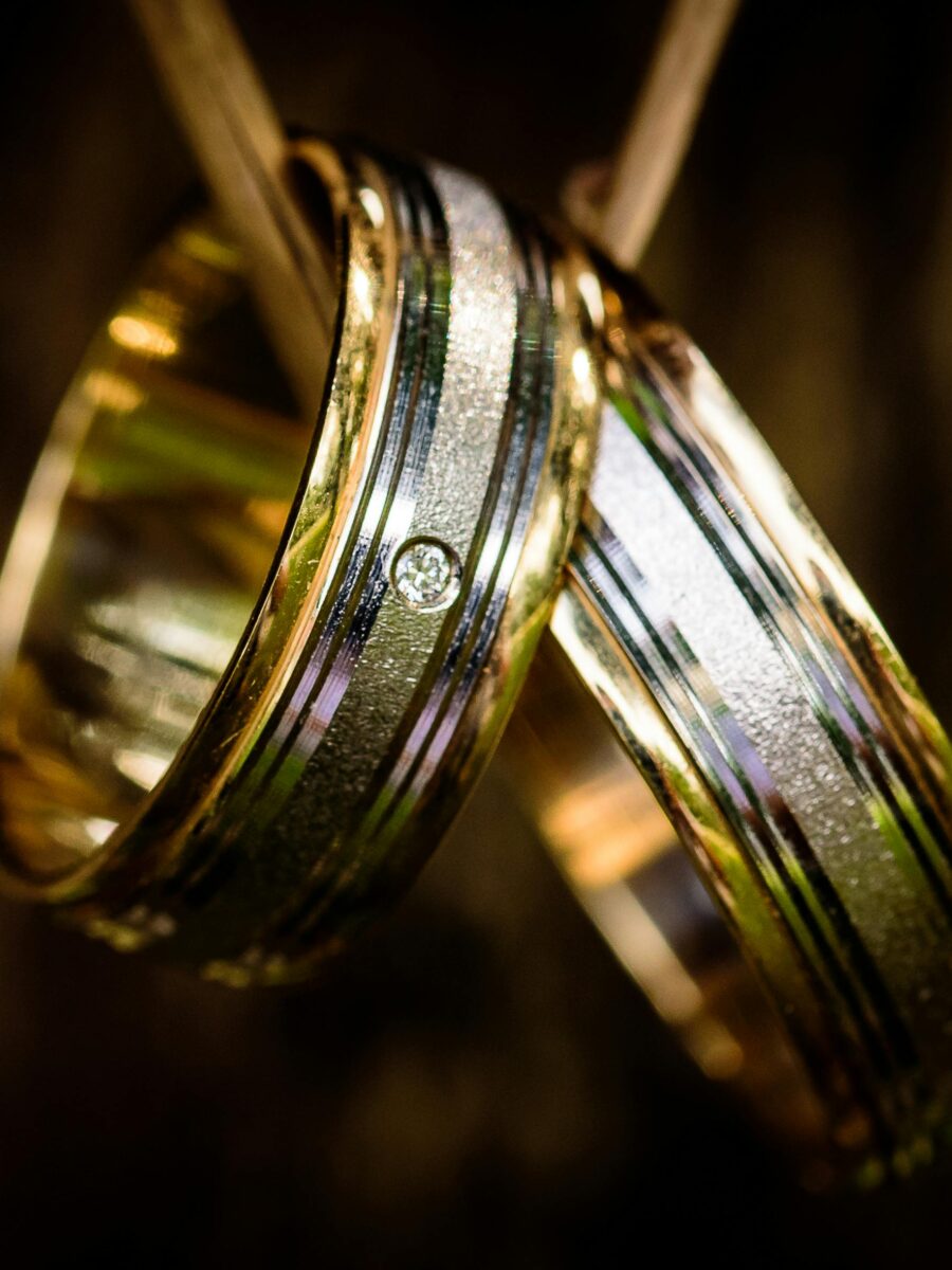 Matching gold wedding band paired with a diamond engagement ring