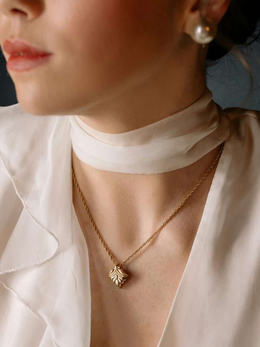 Woman wearing a delicate gold pendant necklace, an elegant gift