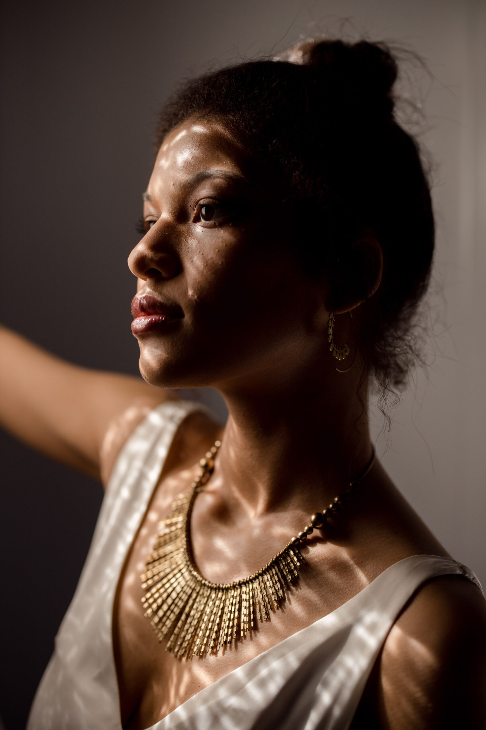 Close-up of a woman wearing a gold necklace, a romantic jewellery gift
